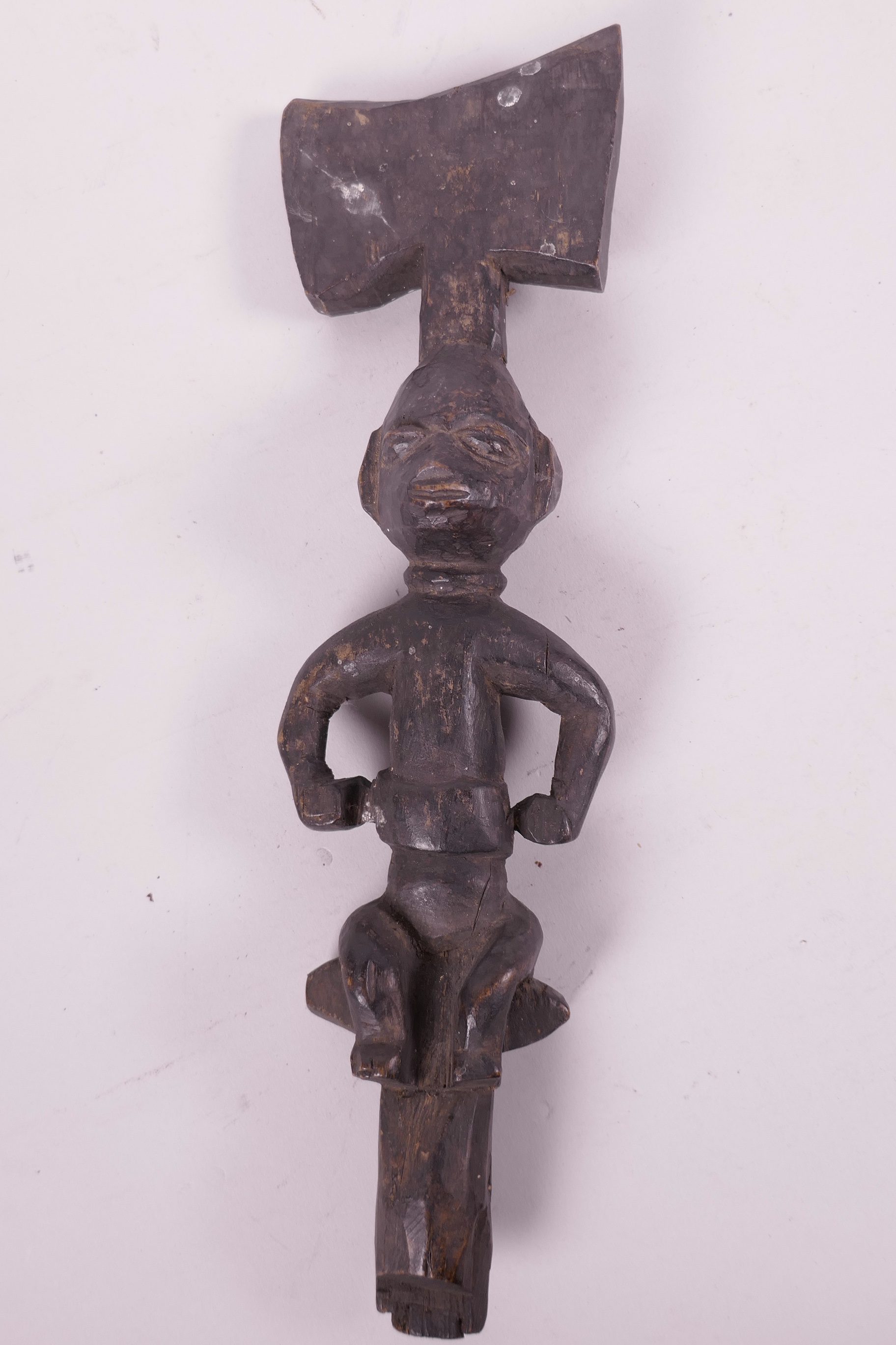 An African carved wood tribal staff, the head carved as a seated figure