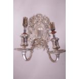 A silver plated two branch electric wall sconce with pierced decoration of cherubs and eagles, 9"