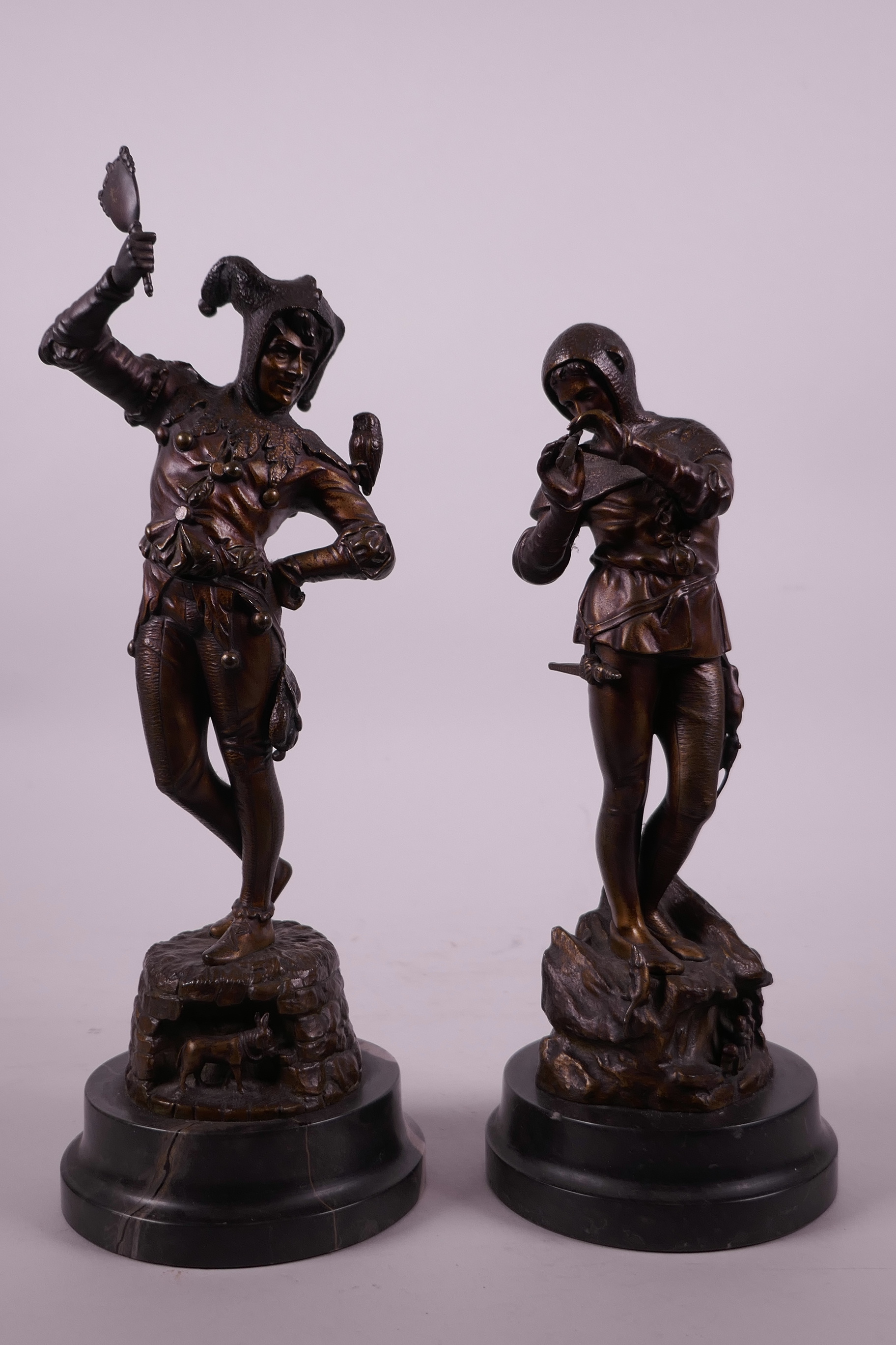 A pair of late C19th bronze figures by E. Barillot, the Pied Piper and a jester, 11" high