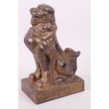 A heavy cast iron doorstop in the form of a seated fo dog, 8" high