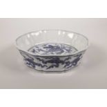 A Chinese blue and white porcelain steep sided dish with a lobed edge, decorated with a five toed