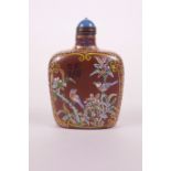 A Chinese redware snuff bottle with polychrome enamel decoration of birds amongst flowers, 3" high