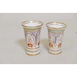 Two hard paste porcelain vases with hand painted decoration and gilt highlights, largest 5" high