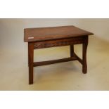 An oak Cotswolds School coffee table with carved decoration, 16" x 23", 8" high
