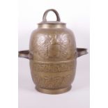 A Continental brass two handled storage jar and cover with embossed decoration of a coat of arms and