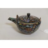 An Oriental teapot/pourer with fine Chinoiserie enamel decoration and gilt washed base and