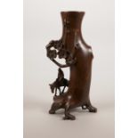 An Oriental coppered bronze spill vase decorated with a sage on horseback, 6" high