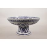A Chinese blue and white pottery stem dish decorated with birds on a fruiting tree branch, 6
