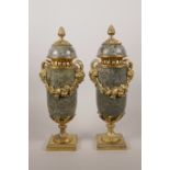 A pair of ormolu mounted marble cassoulets decorated with vine swags and masks of the god Pan,