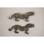 A pair of Chinese bronze scroll weights in the form of a kylin with engraved character decoration,