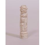 An Oriental carved bone figure of a deity, 4" long
