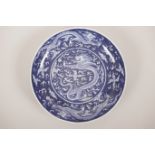 A Chinese blue and white porcelain plate decorated with dragons chasing the flaming pearl, 6