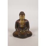 A Chinese bronze figure of Buddha with gilt highlights, 3½" high