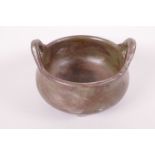 A Chinese tea dust glazed pottery two handled censer, seal mark to base, 4½" diameter