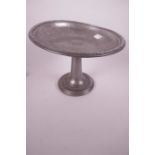 A Tudric pewter pedestal tazza with hammered decoration and cast rim, 9" diameter, 6" high, A/F