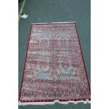 A fine red ground woven silk carpet with all over design, 118" x 78"