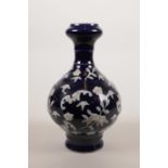 A Chinese blue ground porcelain garlic head vase with raised white enamel decoration of bats,