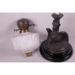 A C19th oil lamp with cast iron base in the form of an eagle, milk glass front and duplex burner,