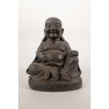 A Chinese bronze of figure of Buddha, with traces of red lacquer, 8" high