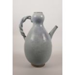 A Chinese pottery jug with a turquoise Jun ware glaze, 10½