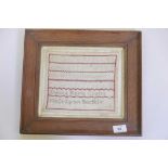 A small sampler, by Emma Maria Coates, King's Lynn, Norfolk, in an oak frame, frame 14" x 12"