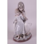 A Lladro porcelain figurine of a mother and child, 1527, 9" high