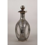 A moulded dimple glass decanter bound with Chinese Wai Kee silver mounts, decorated with Oriental