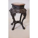 A Chinese hardwood stand, with carved and pierced decoration of bats, bamboo and cherry blossom,