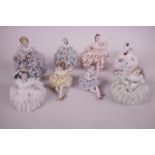 Eight Irish Dresden porcelain figurines of girls in elaborate lace dresses