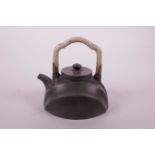 A Chinese teal ground Yixing teapot with a carved hardstone handle and white metal mounts, impressed