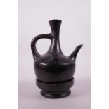 An African black lacquered terracotta ewer and stand, 9" high