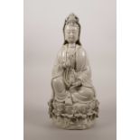 A Chinese blanc de chine porcelain figure of Quan Yin seated on a lotus throne, impressed marks