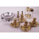 A collection of brass chamber sticks and taper holders, and a French pewter bowl with ring