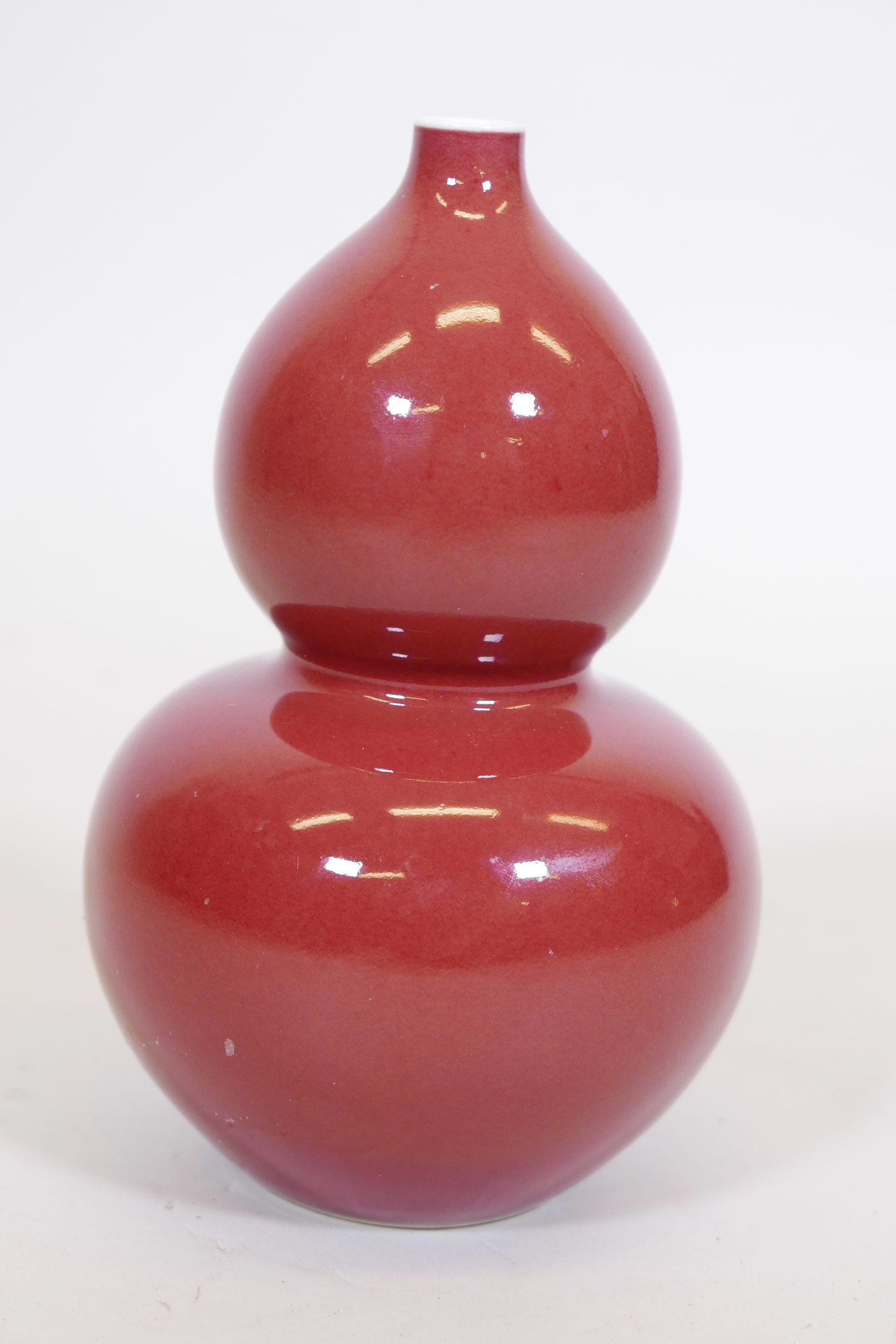 A Chinese sang de boeuf glaze double gourd vase, with blue seal mark to base, 9" high