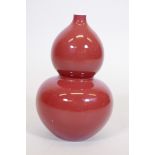 A Chinese sang de boeuf glaze double gourd vase, with blue seal mark to base, 9" high