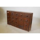 A C19th mahogany flight of twenty drawers, 24" x 40" x 9"