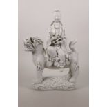 A Chinese blanc de chine figure of Quan Yin riding a kylin, impressed seal marks verso, 12" high