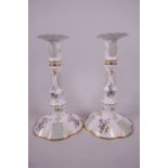 A pair of Halcyon Days enamel candlesticks decorated with flowers in the classical manner, 6½" high