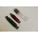A Victorian double ended green glass scent bottle with white metal mounts, 5" long, a red glass