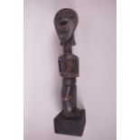 An African carved wood ritual figure, 13" high