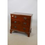 A Regency style mahogany chest of three drawers, with brass plate handles, raised on bracket