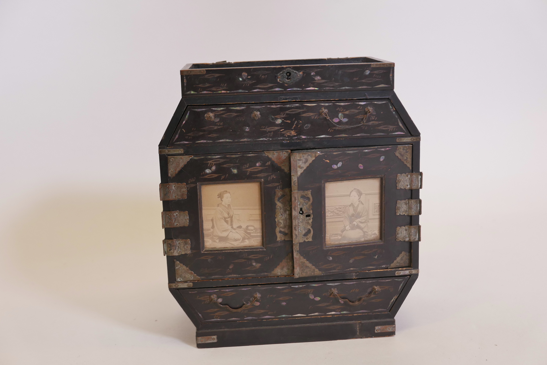 A Meiji lacquered table cabinet with gilt and mother of pearl inlaid decoration and metal mounts,