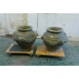 A large pair of Coade stone urns with classical decoration, 22" high