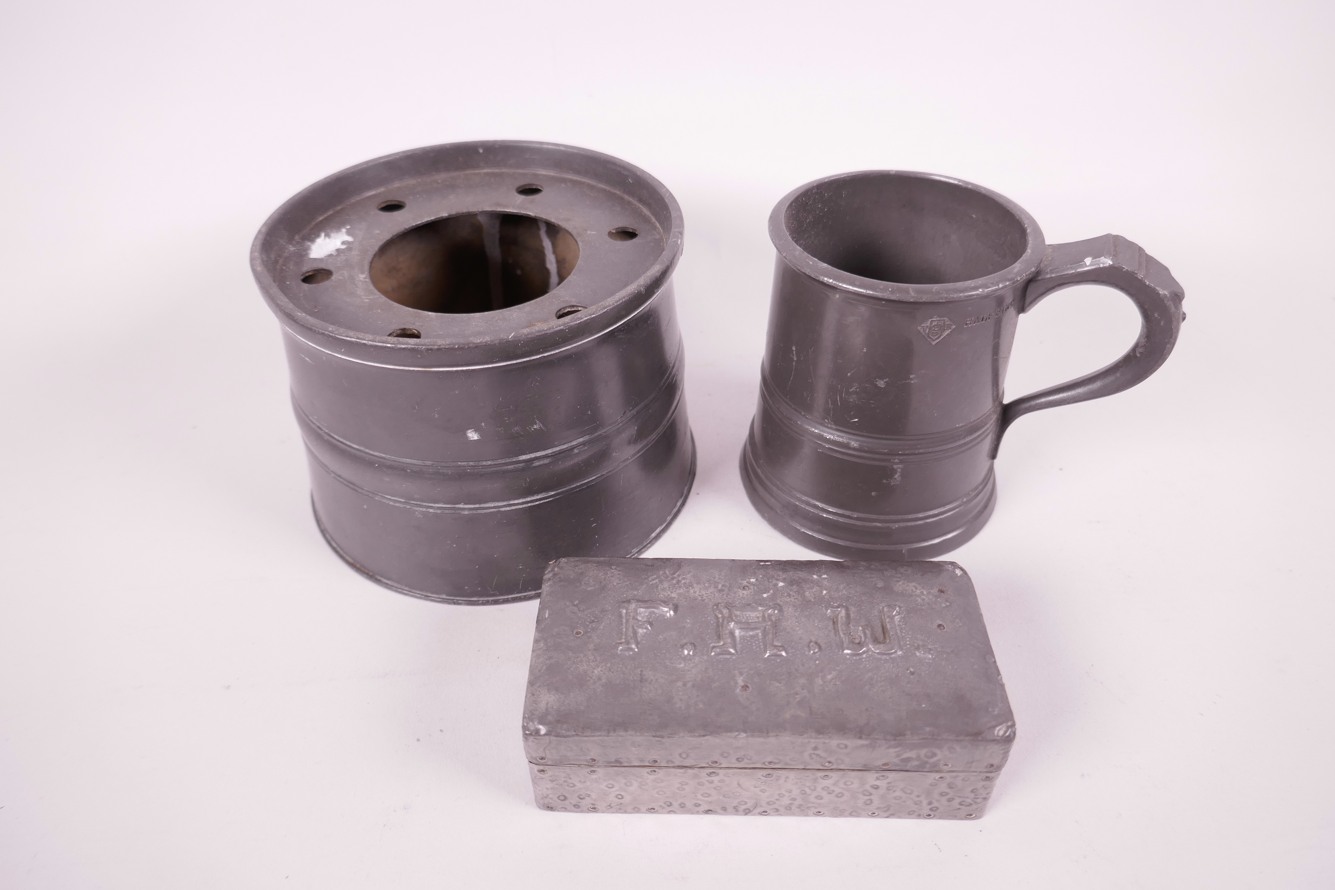 A C19th pewter inkwell, 4½" diameter, a Victorian half pint tankard, and a pewter stamp box