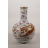 A Chinese polychrome porcelain vase decorated with a red and gilt dragon chasing the flaming