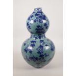 A Chinese porcelain double gourd vase with blue on blue decoration of gourds and bats, seal mark