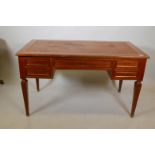 A Continental mahogany and brass mounted five drawer desk, with leather inset slides to each end and