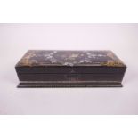 A Victorian black lacquered papier mache glove box with painted floral spray and inset abalone