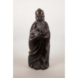 A substantial Chinese carved hardwood figure in the form of the deity Fu, 15" high