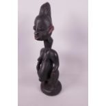 An African carved wood fertility figure of a pregnant woman, 15" high